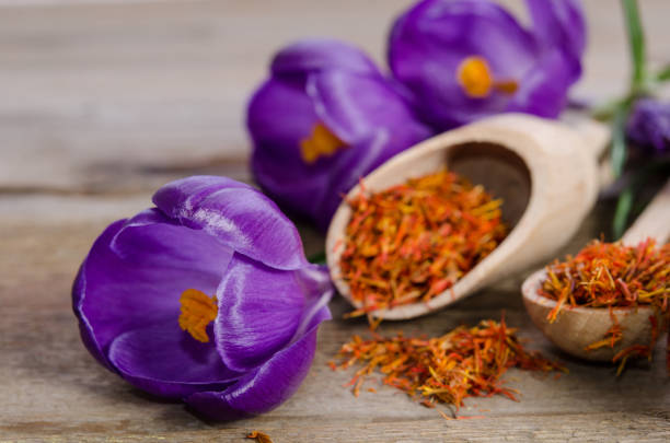istock crocus flowers and spoon with soffron  on wooden table 680923132