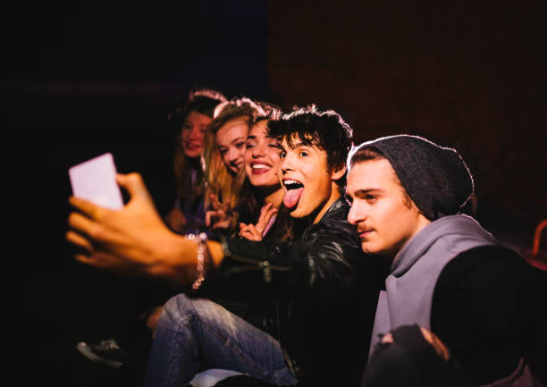istock Group of hipster friends taking a selfie at night 680926414