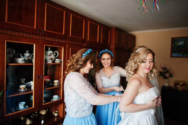 istock Bridesmaids and bride preparing at room on wedding morning. 680929430