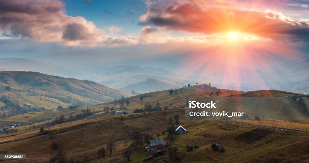 Panoramic landscape of the spring mountains at sunset. Panoramic landscape of the spring mountains at sunset. View of a hilly countryside. Atmospheric Mood Stock Photo