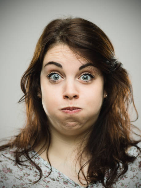 istock Disgusted young woman blowing cheeks 680940940