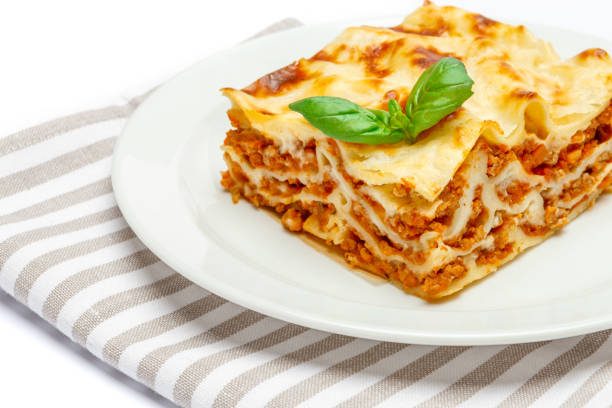 istock Portion of tasty lasagna isolated on white 680955210