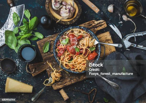 Spaghetti With Tomato And Basil And Ingredients For Making Pasta Stock Photo - Download Image Now