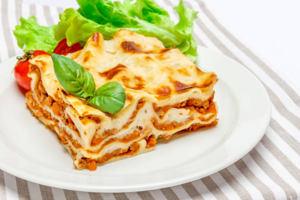 istock Portion of tasty lasagna isolated on white 680956154