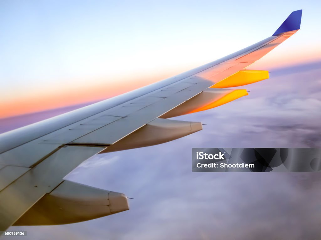 Morning sunrise with Wing of an airplane. Traveling concept Advertisement Stock Photo