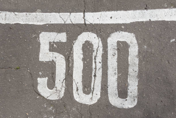 istock Number 500, five hundred, painted on asphalt 680960256