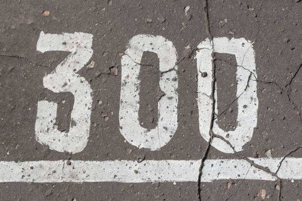 istock Number 300, three hundred, painted on asphalt 680960258
