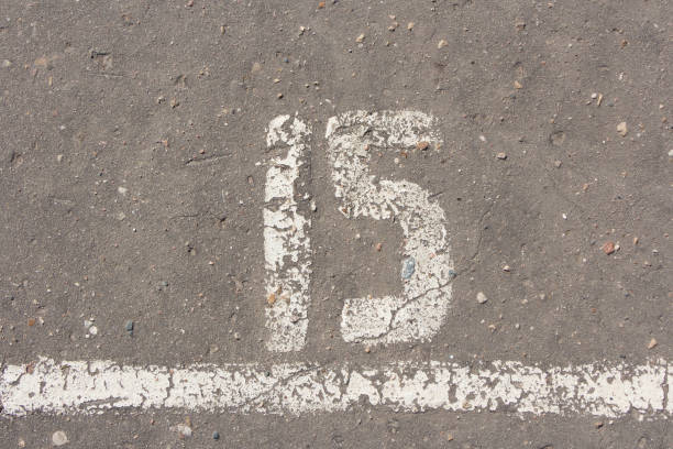 istock Number 15, fifteen, painted on asphalt 680960584