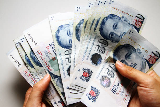 Money background Money is any item or verifiable record that is generally accepted as payment for goods and services and repayment of debts in a particular country singapore cash stock pictures, royalty-free photos & images