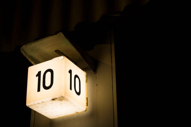 istock Bold number ten sign shining against large dark background 680982928