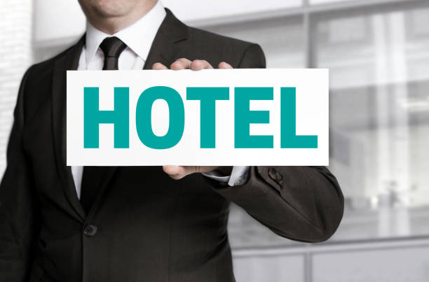 istock hotel sign is held by businessman concept 680990854