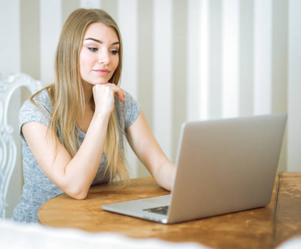 istock Beautiful young woman working with laptop 680992554