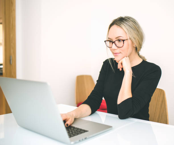 istock Beautiful young woman working with laptop 680993626
