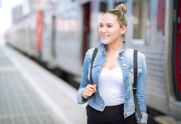 istock Woman traveler with backpack on rail station checking time 680993946