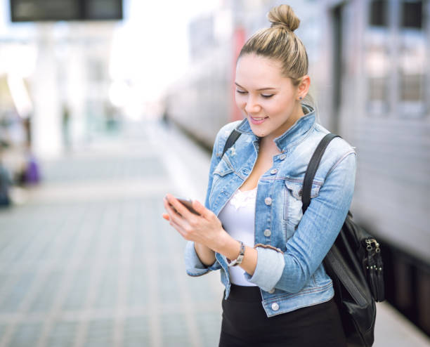 istock Beautiful young woman in real life using smartphone 680995344