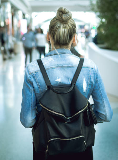 istock Young woman with backpack walking on the european streets 680995366