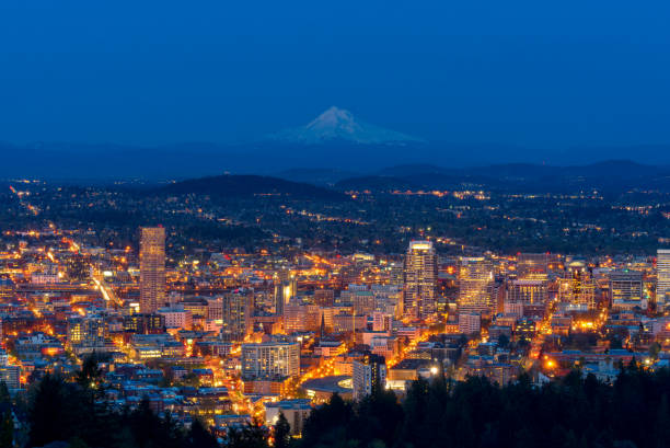 Portland city with mount Hood in a background during dusk. Portland cityscape with Mount Hood and clear sky in background, Oregon, United States mt hood photos stock pictures, royalty-free photos & images