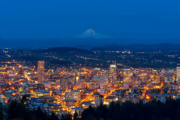 Photo of Portland city with mount Hood in a background during dusk.