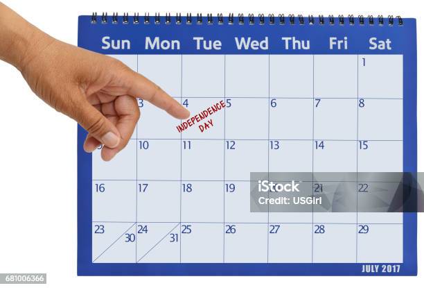 July 2017 Calendar Hand Pointing To Independence Day Stock Photo - Download Image Now