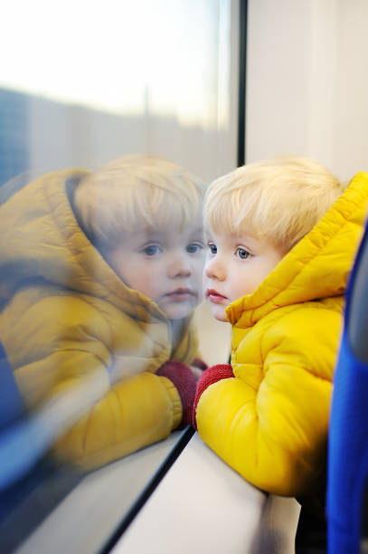 istock Cute toddler boy looking out train window outside 681015176