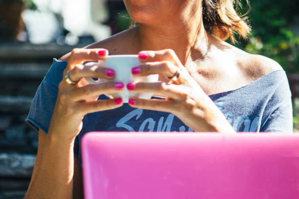 istock Woman with coffee and pink laptop 681020436