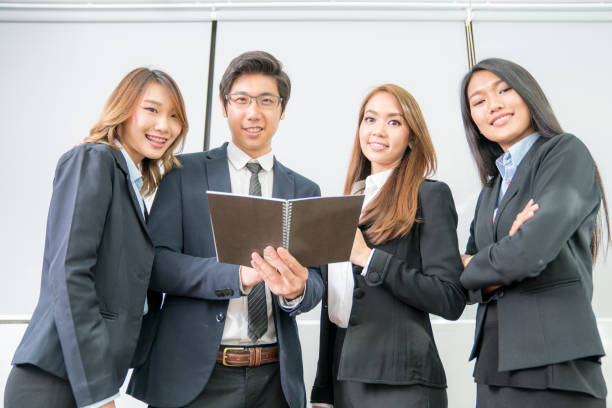 istock Young aged Asian business team meeting in office wiht notebook. 681043208