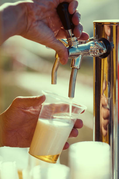istock barman hand at beer tap pouring a draught lager beer 681049490