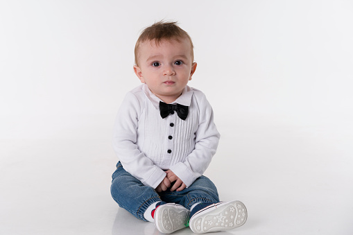 Nine Month Old cute Baby Sitting on White Background