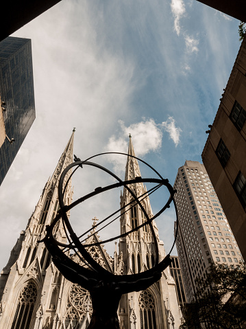 St Patrick's Cathedral is visible behind a statue of Atlas