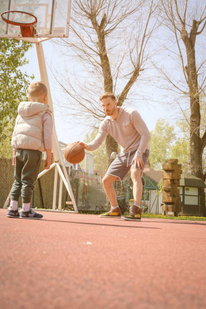 istock Father and son playing basketball. 681058080