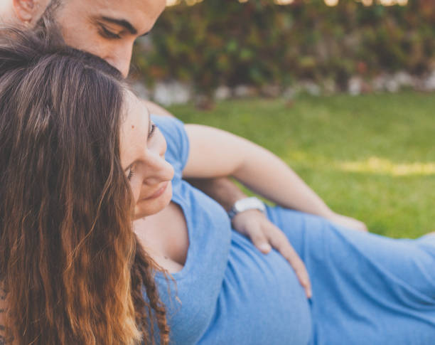 istock Young couple embraces expecting first child 681062170