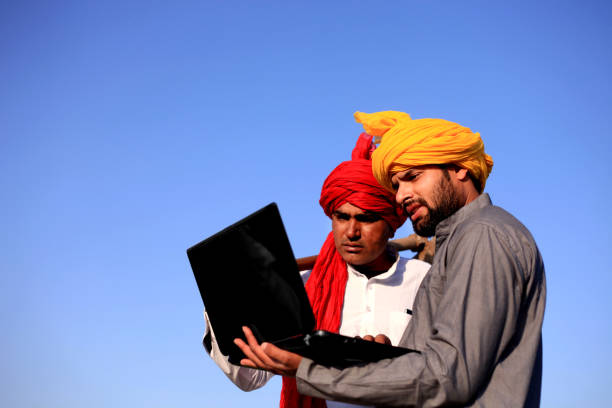 istock Two farmer using laptop outdoor in the nature 681082360