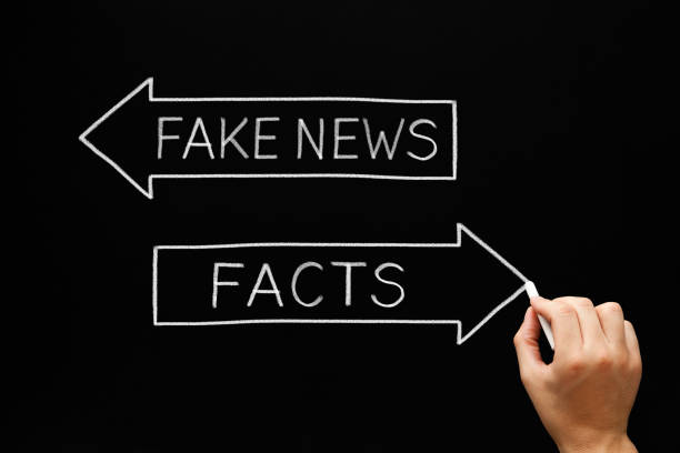Fake News Or Facts Arrows Concept Hand sketching Fake News or Facts concept with white chalk on blackboard. populism stock pictures, royalty-free photos & images