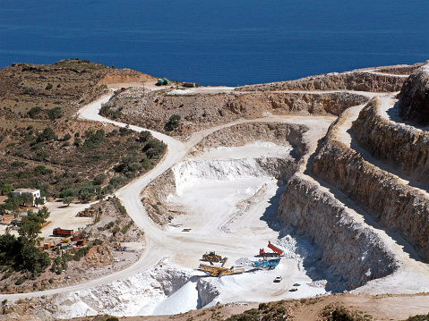 Panorama of gypsum quarry on Crete island. Open quarry is located at Altsi in Sitia municipality and operated following method of exposed vertical benches.