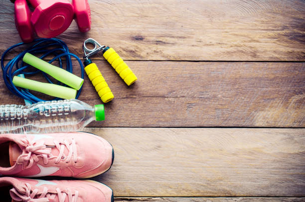 istock fitness concept with Exercise Equipment on wooden background. 681097144