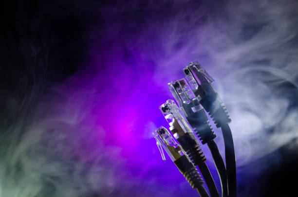 istock Network switch and ethernet cables, symbol of global communications. Colored network cables on dark background with lights and smoke. Selective focus 681122080