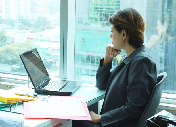 istock business woman looking at laptop 681133264