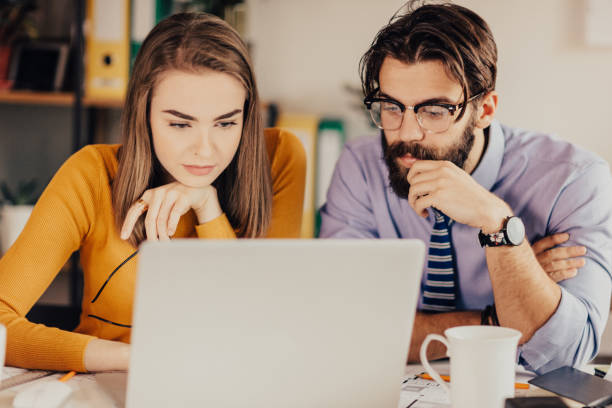 istock Businesswoman and businessman using laptop 681149310