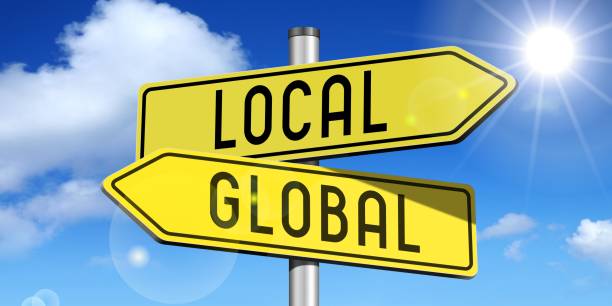 istock Local, global - yellow road-sign 681155264
