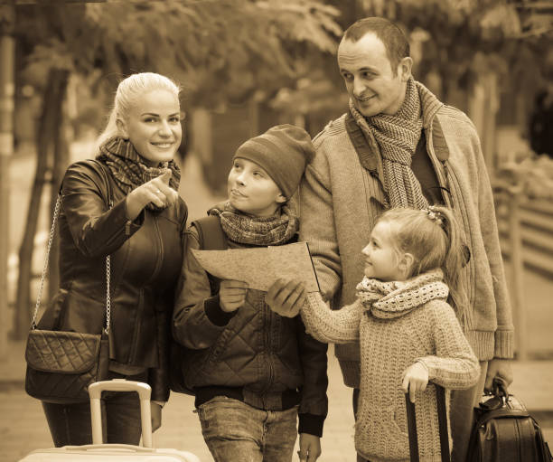 istock Parents with two kids and baggage with map 681155812