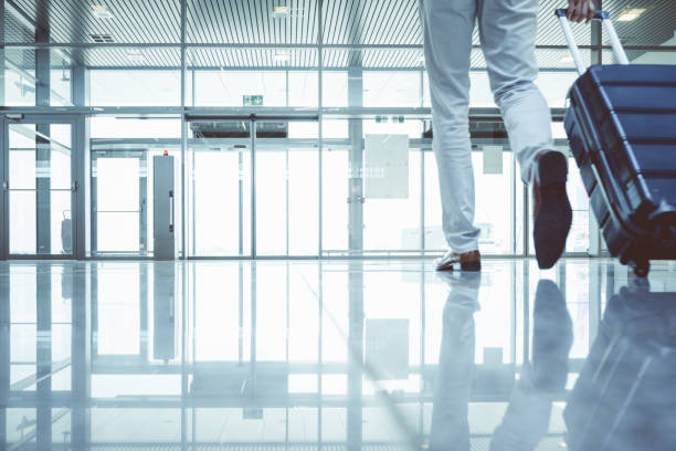 istock Businessman walking with suitcase at airport terminal 681169932