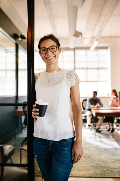 istock Relaxed woman in office doorway with coffee 681176814
