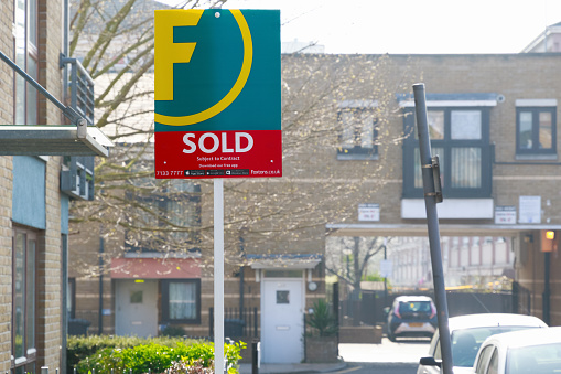 London, UK - March 27, 2017 - Estate agency sold sign outside a English townhouseLondon, UK - March 27, 2017: Estate agency sold sign outside a English townhouse