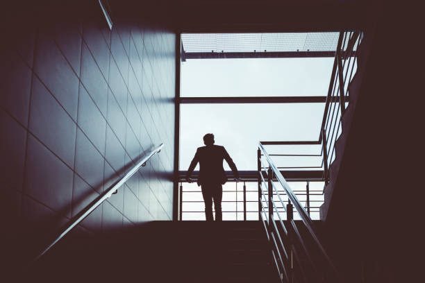 istock Silhouette of a man standing on steps at airport 681179244