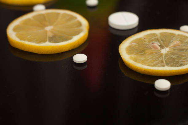 istock Close up, lemon slice and pills, flu medicine, front view, copy space 681182124
