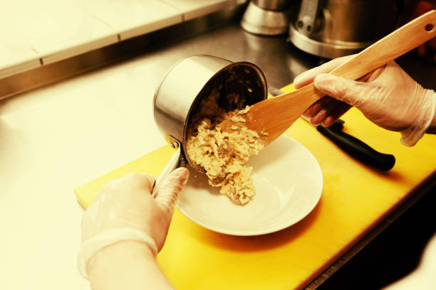 Chef is putting risotto in plate, toned