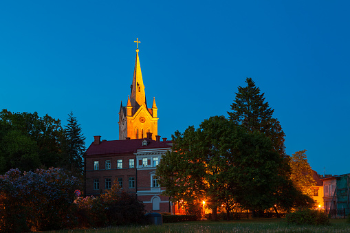 Old town street and church at summer night. Cesis, Latvia