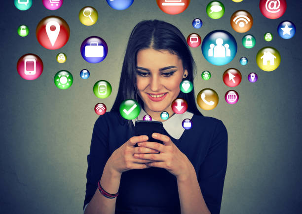 istock Woman using smartphone with application icons flying out of screen 681205858