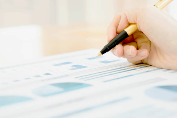 istock Businesswoman holding a pen and analyze data 681207814