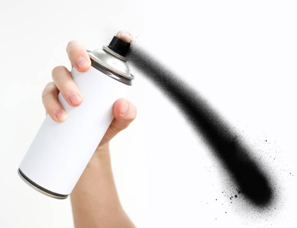 istock Man's hand holds a spray of black paint. Isolated on a white background 681213656